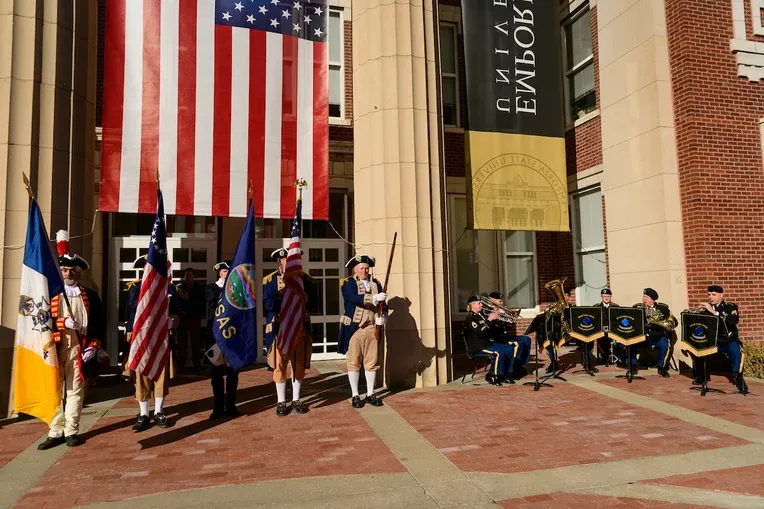 Flag celebration in front of Emporia State's Plumb Hall